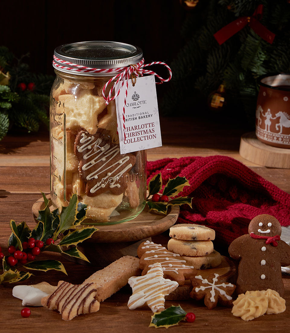 Christmas biscuits in glass jar with red striped ribbon, artisan British shortbread and gingerbread gifts