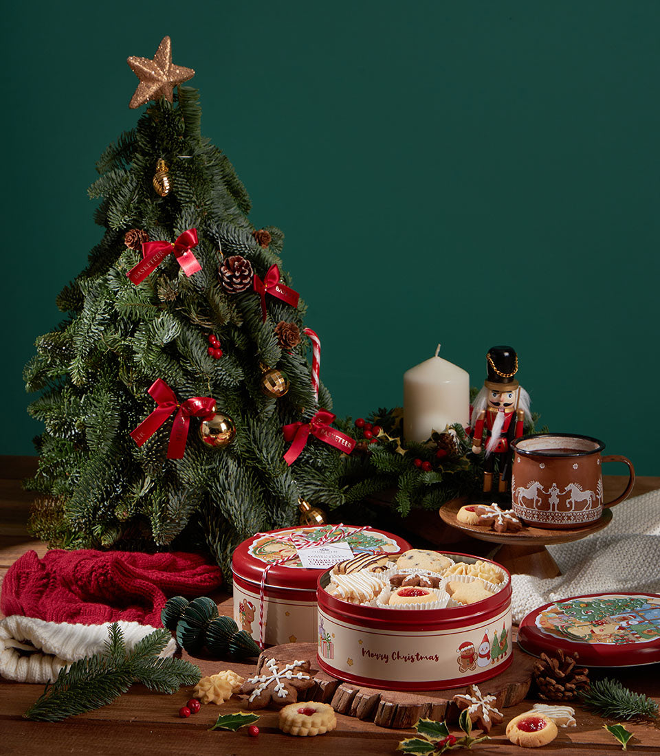 Grandma Amy's Christmas Biscuit Collection red and cream festive sharing tins with assorted cookies, gold-decorated tree,