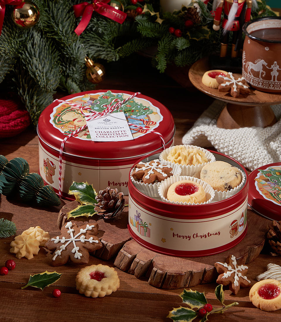 Festive red tin with assorted Christmas cookies including gingerbread snowflakes, butter cookies, and jam shortbread in