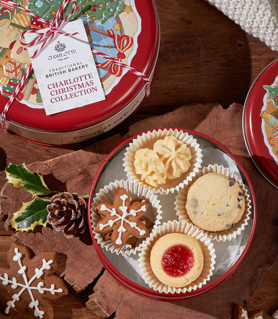 Charlotte Bakery's Christmas biscuit collection in a festive tin. Artisan-baked British pastries include shortbread and jam-filled cookies. Perfect for gifting in Bangkok.