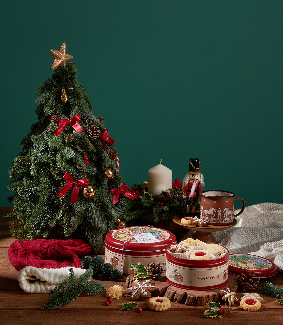 Grandma Amy's Christmas biscuit collection in festive red and white tins with shortbread, jam tarts, and gingerbread cookies