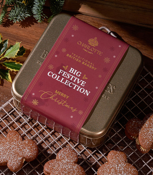 Cream stuffed gingerbread fatties in festive gold tin with holly and powdered sugar dusting