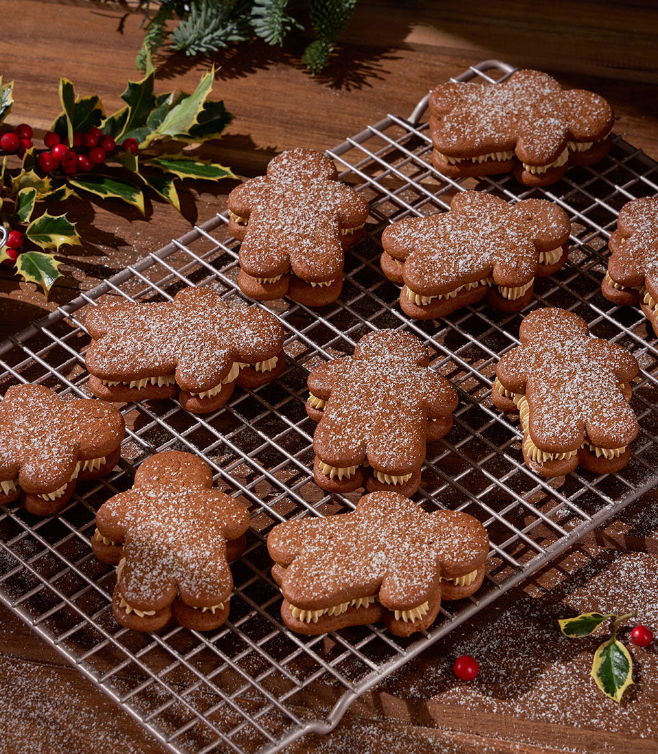 Cream-filled gingerbread fatties with powdered sugar dusting, festive Christmas bakery gift set