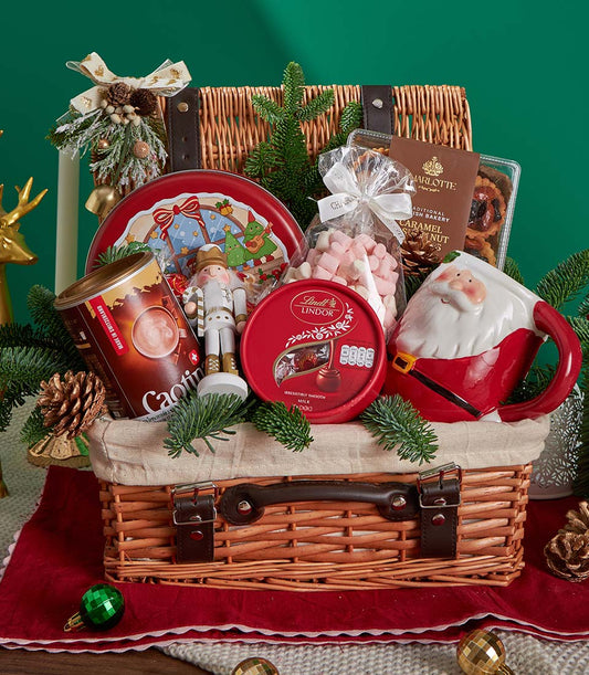 Festive Christmas gift basket with gourmet chocolate, Swiss hot chocolate, biscuits and holiday treats in woven wicker with