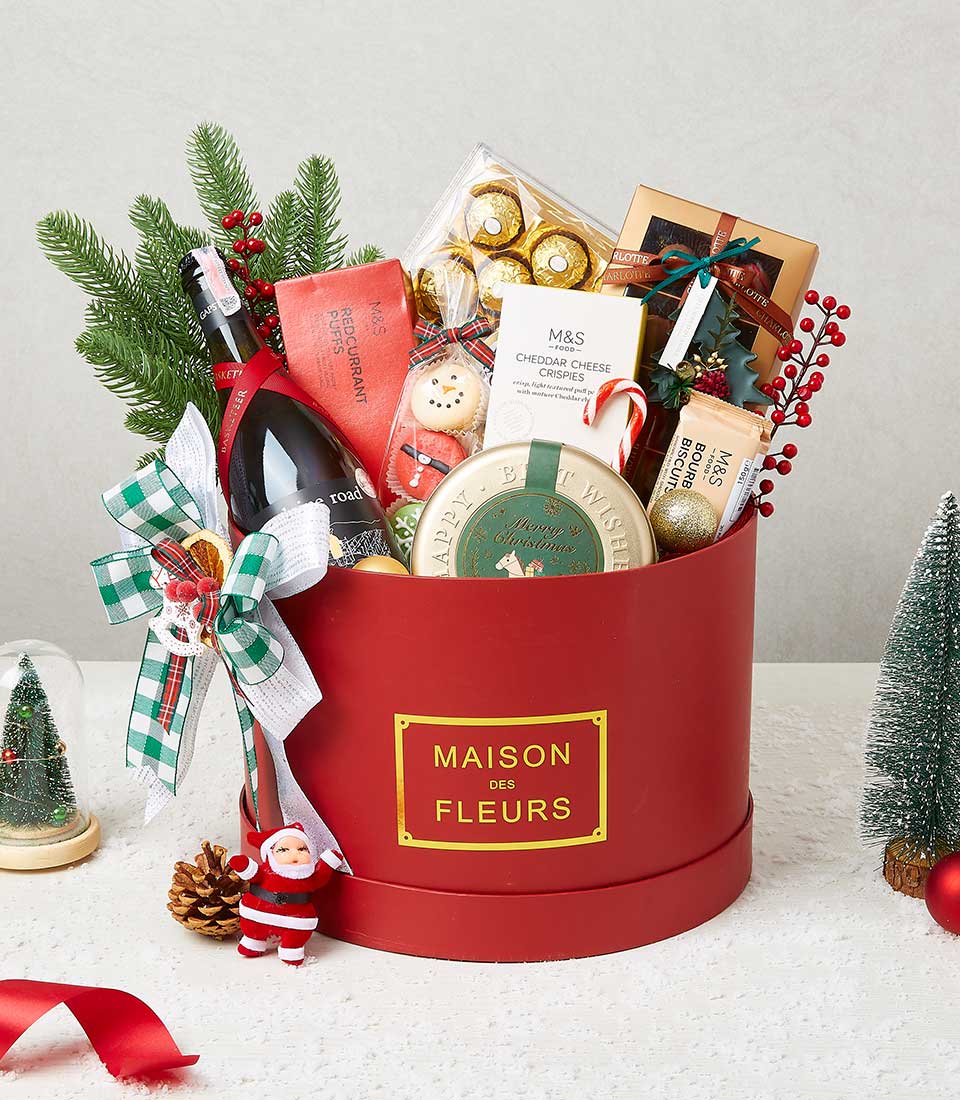Festive Christmas wine gift box with sparkling wine, gourmet snacks, and holiday treats in luxury red packaging