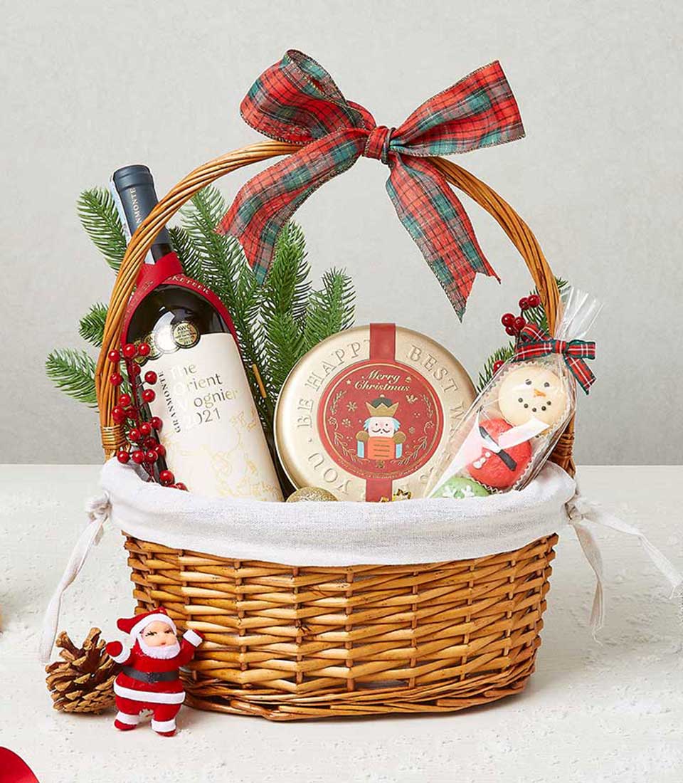 Wicker Christmas wine basket with award-winning white wine, gourmet treats, and festive holiday decor