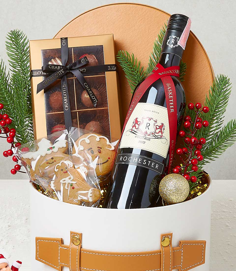 Red wine with artisan chocolates and gingerbread in festive Christmas gift box