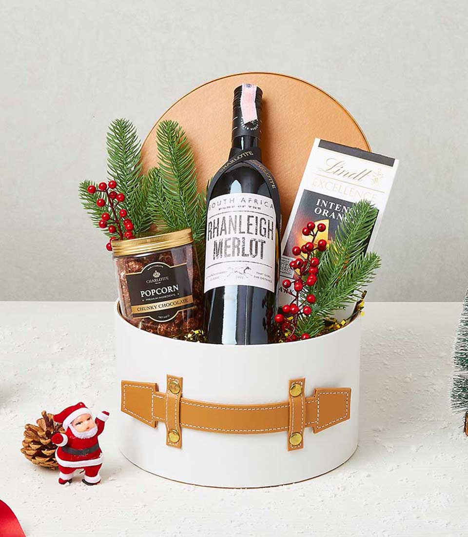 Premium Christmas wine and gourmet snacks gift hamper in leather-trimmed box with Merlot and chocolate treats