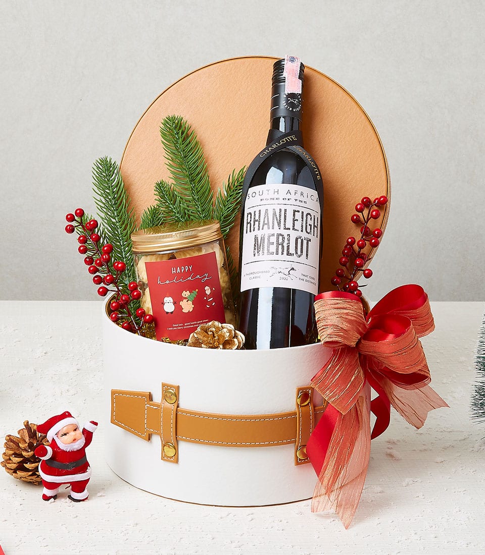Premium red wine and cookies festive gift set in white box with holiday ribbon and pine decoration