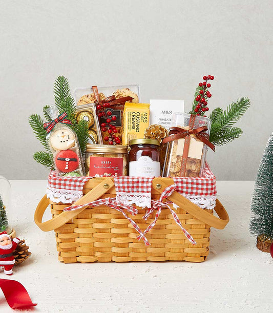 Festive Christmas gift basket with gourmet treats, cookies, custard creams, chocolate, jam, and holiday decorations