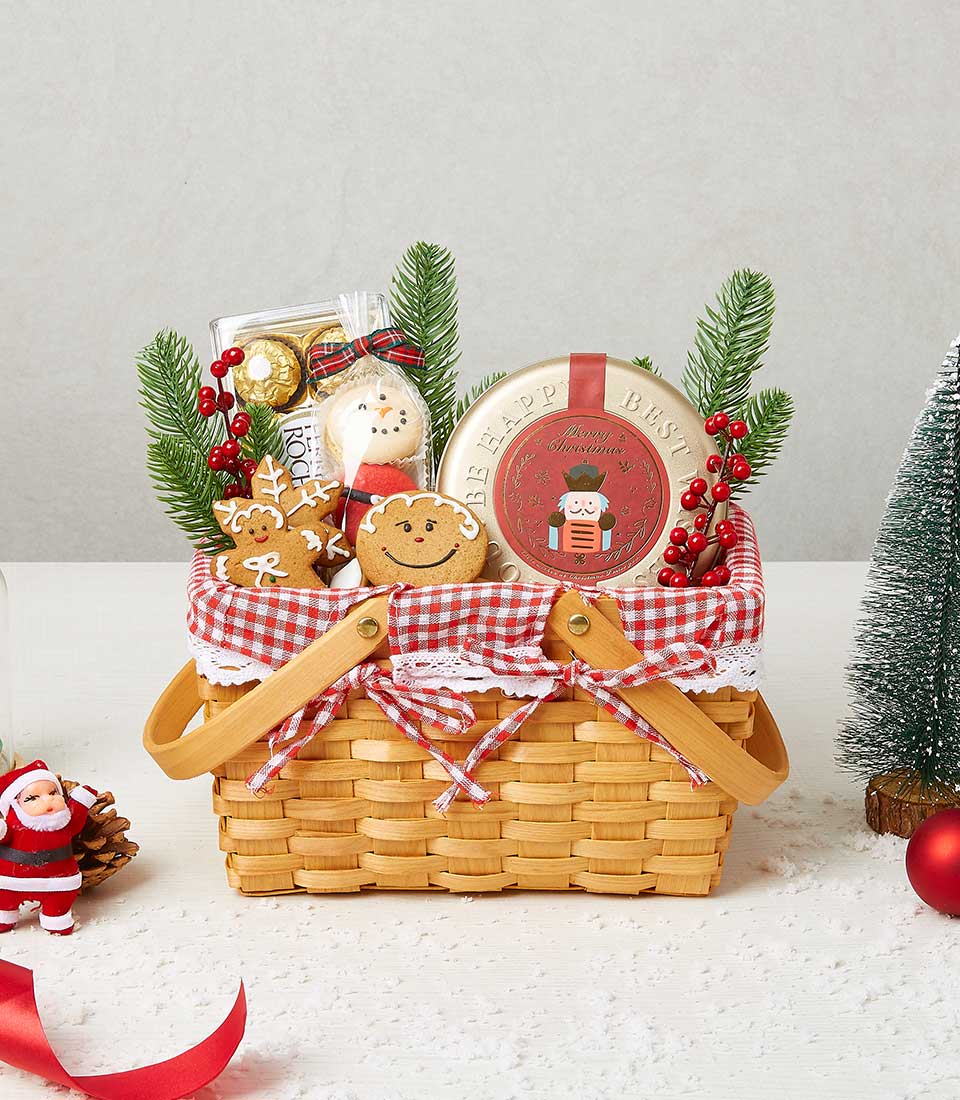 Festive Christmas snack basket with woven handles, gingham linen, gingerbread treats, gold chocolates, and holiday tin