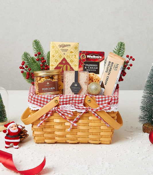 Festive wicker gift basket with gourmet chocolates, biscuits, popcorn and honeycomb, tied with red gingham ribbon