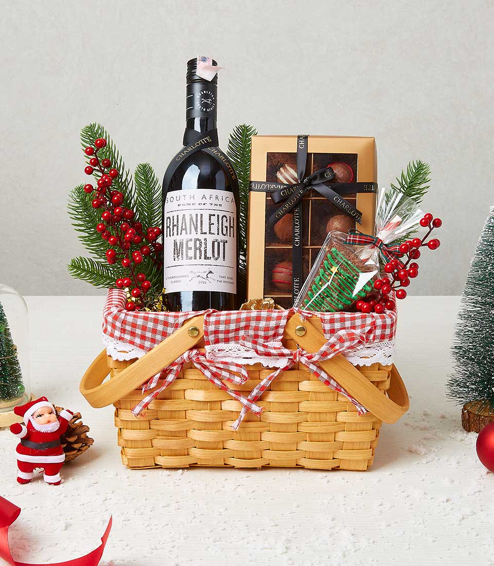 Premium red wine and chocolate Christmas gift basket with gingham ribbon and festive decorations