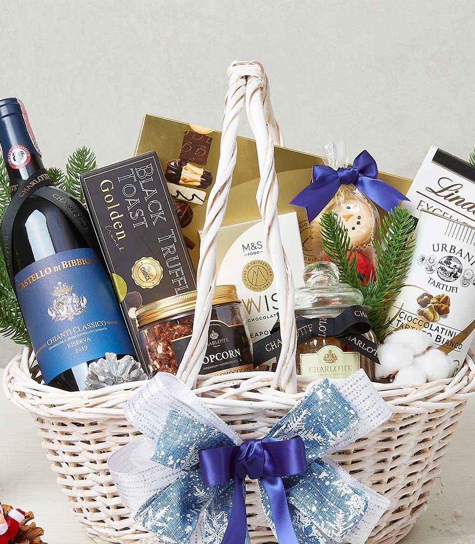 Festive Vineyard Treasures white wicker basket with Chianti Classico wine, truffle chocolates, and gourmet treats, tied with