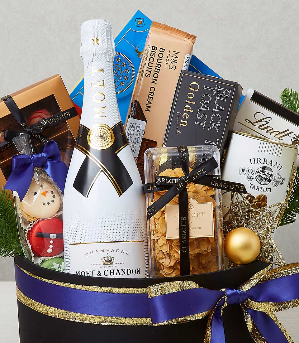 Luxury Christmas champagne hamper with gourmet treats, gold and blue ribbon in black container