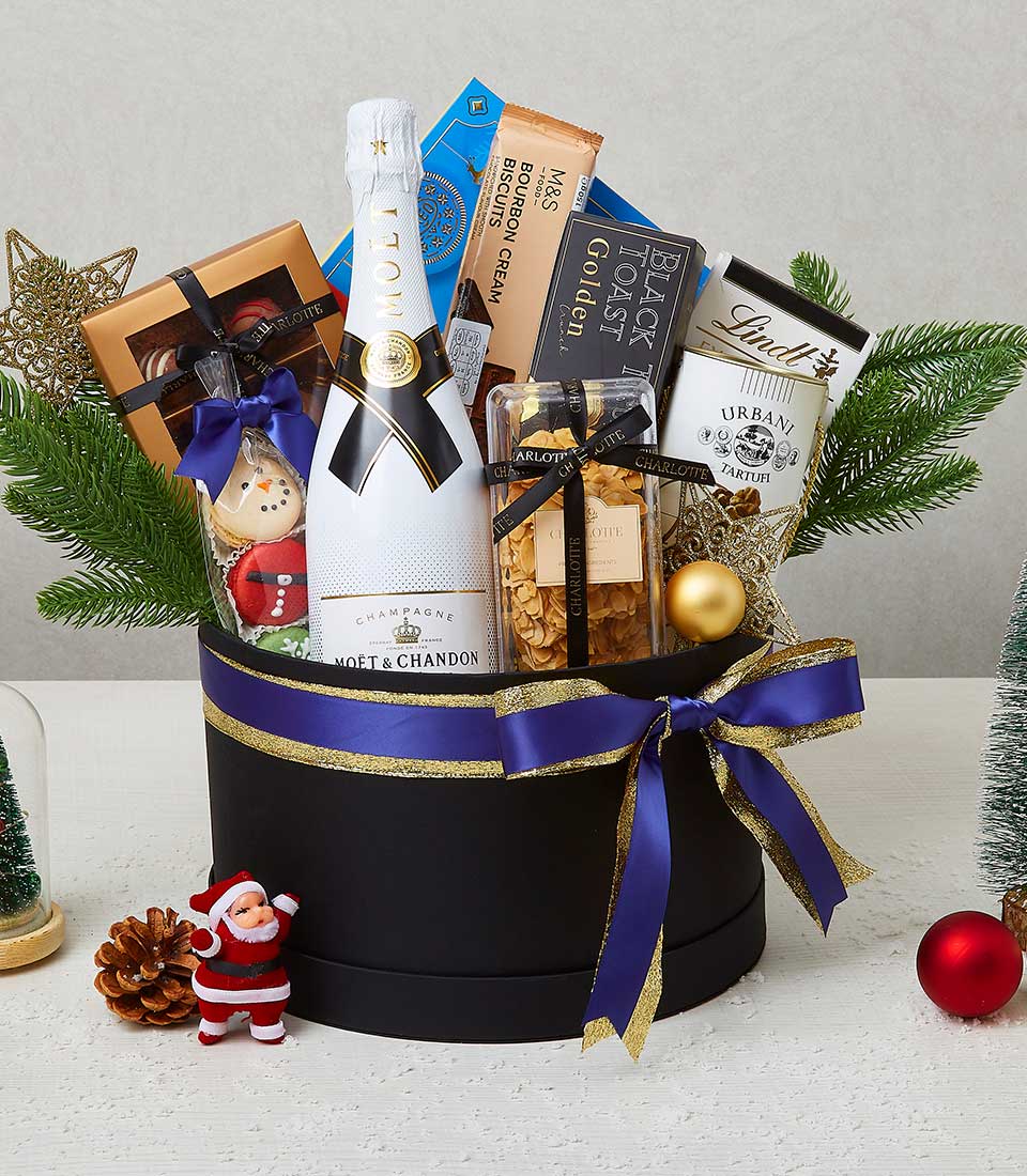 Premium Christmas champagne hamper with gourmet pastries, truffles, and festive treats in luxury black gift box