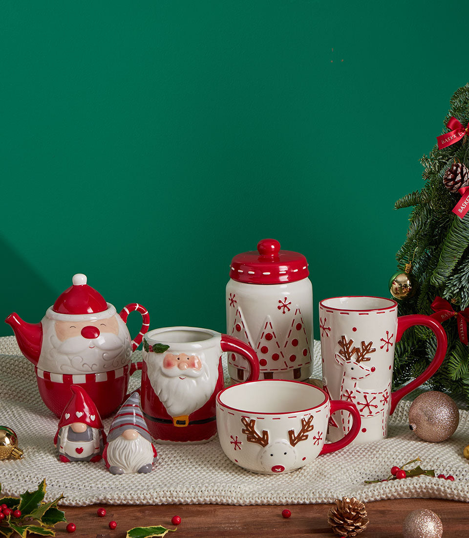 Festive Basketeer Christmas gift featuring a Santa teapot, holiday mugs, and gnome figurines for a joyful family gathering. Perfect premium hamper delivery in Thailand.