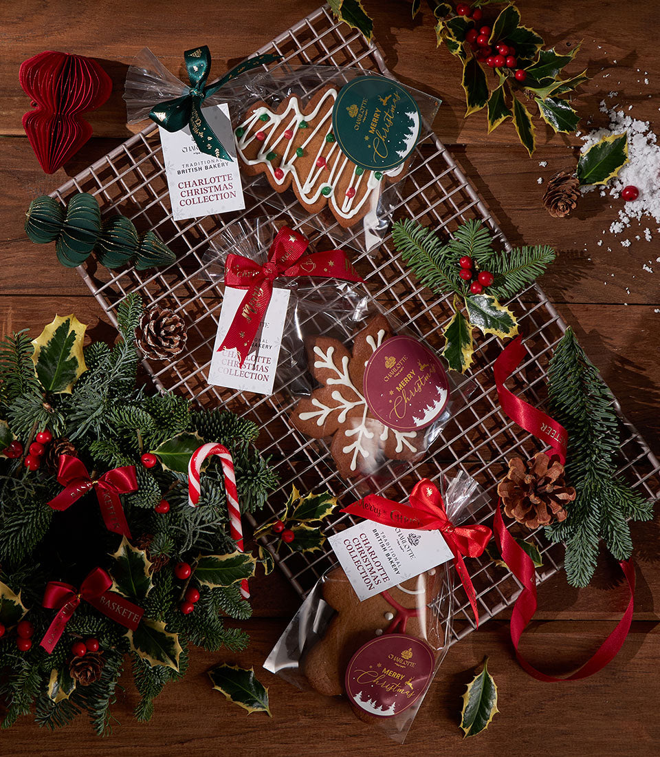 Assorted Christmas gingerbread cookies with festive ribbons on cooling rack, holiday gift set