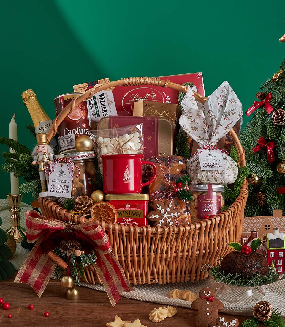 Luxury Christmas hamper with gourmet chocolates, tea, hot chocolate, shortbread, and festive treats in wicker basket with