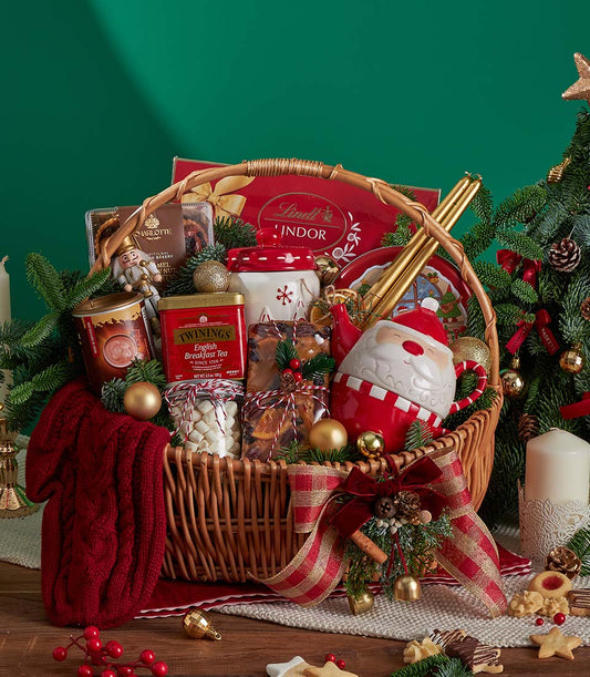 Luxury Christmas gift basket with premium tea, chocolate, fruitcake, festive teapot and knitted throw in wicker