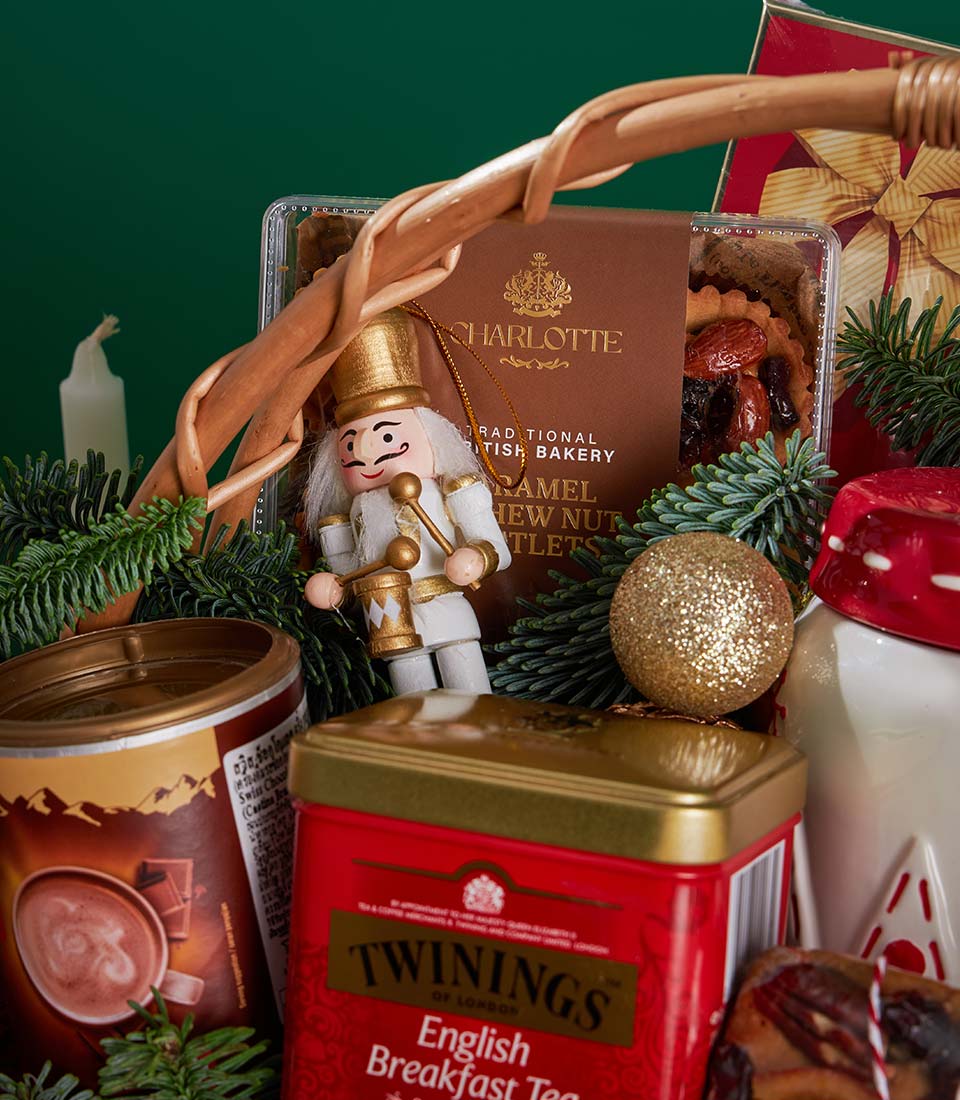 Luxury Christmas gift basket with Charlotte Bakery cashew tartlets, Twinings tea, hot chocolate, nutcracker and gold baubles
