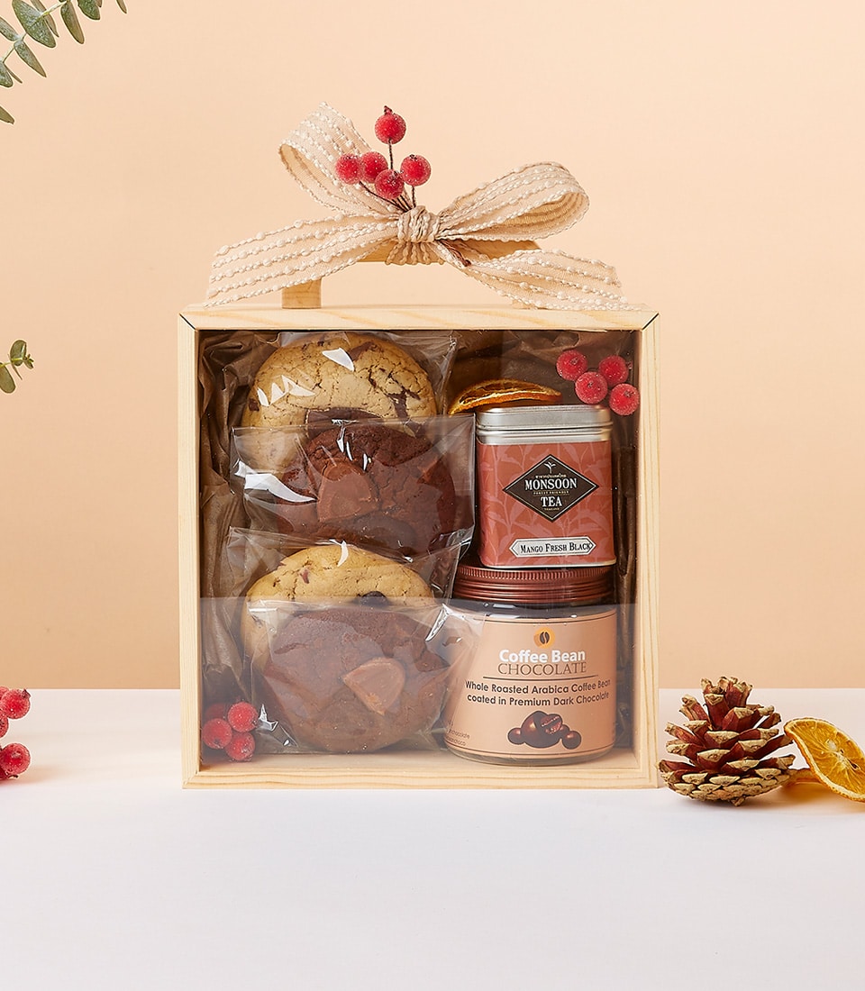 Nourish & Thrive wellness gift set with chocolate-chip cookies, mango tea, dark chocolate coffee beans in wooden box with