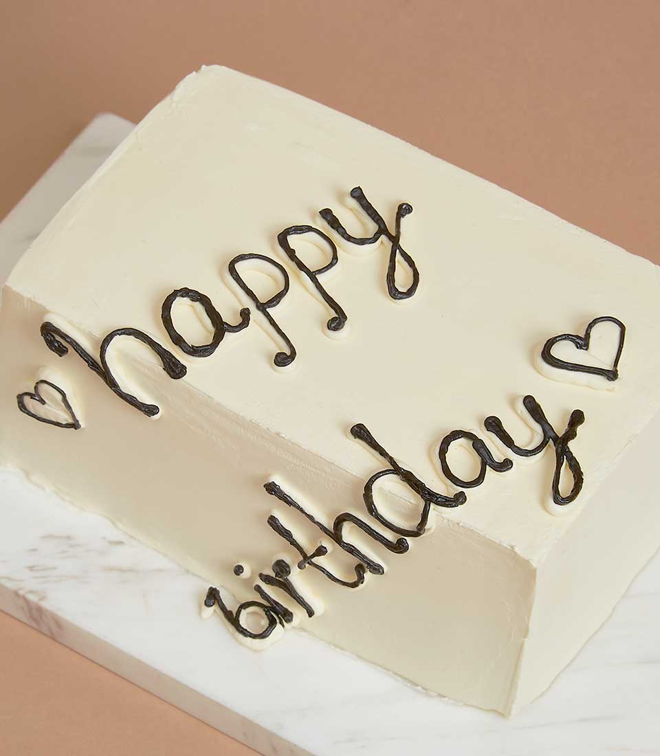 Vanilla strawberry jam layer cake with cream frosting and happy birthday script message