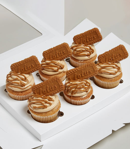 Eight Lotus Biscoff cupcakes with caramel frosting and cookie garnish in white gift box
