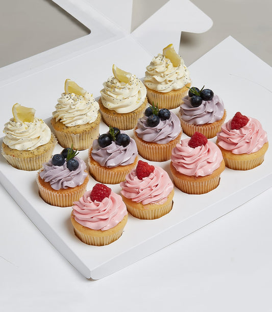 Dozen artisan cupcakes with lemon poppy, blueberry rosemary, and raspberry frosting in white gift box