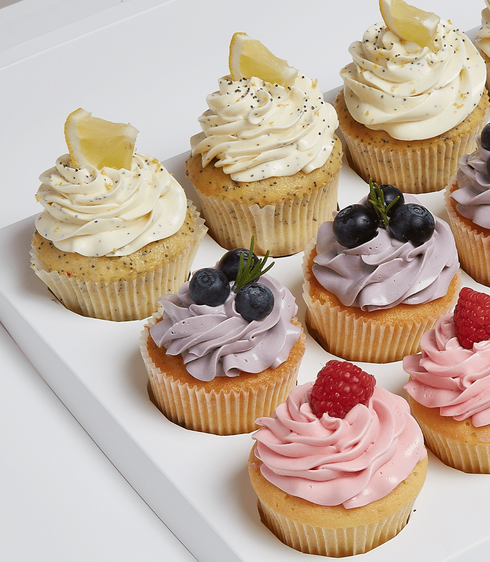 Assorted dozen gourmet cupcakes with lemon poppy seed, blueberry, and raspberry flavours in white presentation box