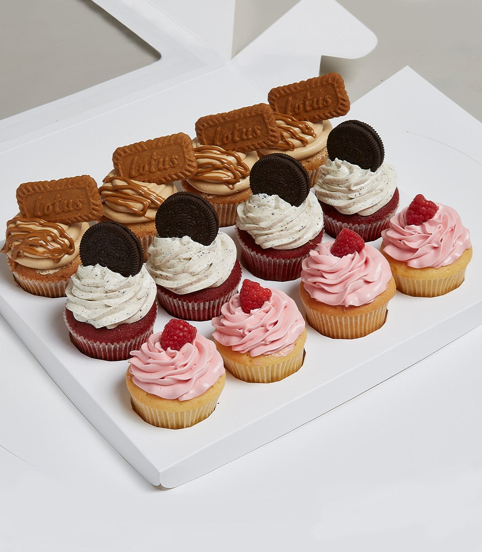 Assortment of twelve artisan cupcakes with Biscoff cookies, red velvet, and raspberry vanilla in white presentation box