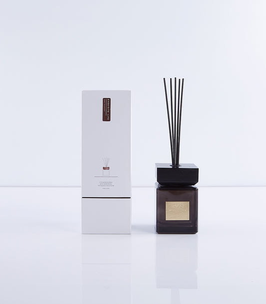 Ebony wood fragrance diffuser with dark glass bottle and black reeds, premium home gift set