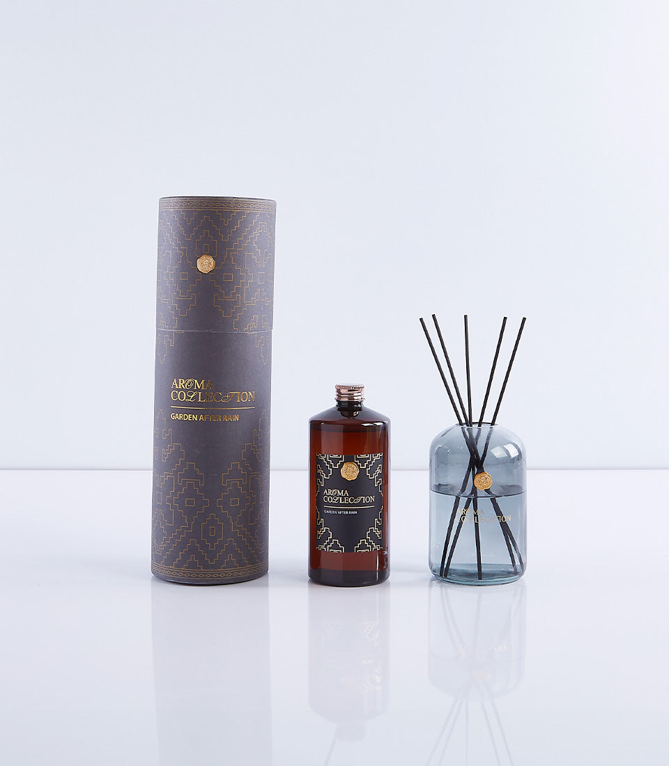 Luxury hotel aroma diffuser set with amber glass bottle, grey-blue diffuser, and geometric patterned tube in Garden After