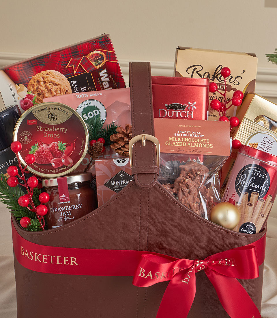 Luxury brown leather tote filled with gourmet cocoa, coffee, and artisan treats tied with red satin ribbon, perfect for New