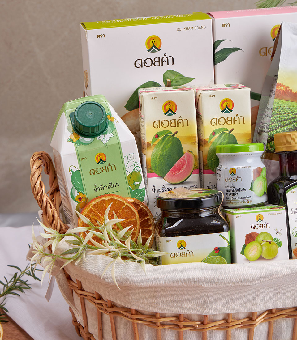 Doi Kham wellness gift basket with guava juice, vegetable drink, and artisan preserves in woven wicker