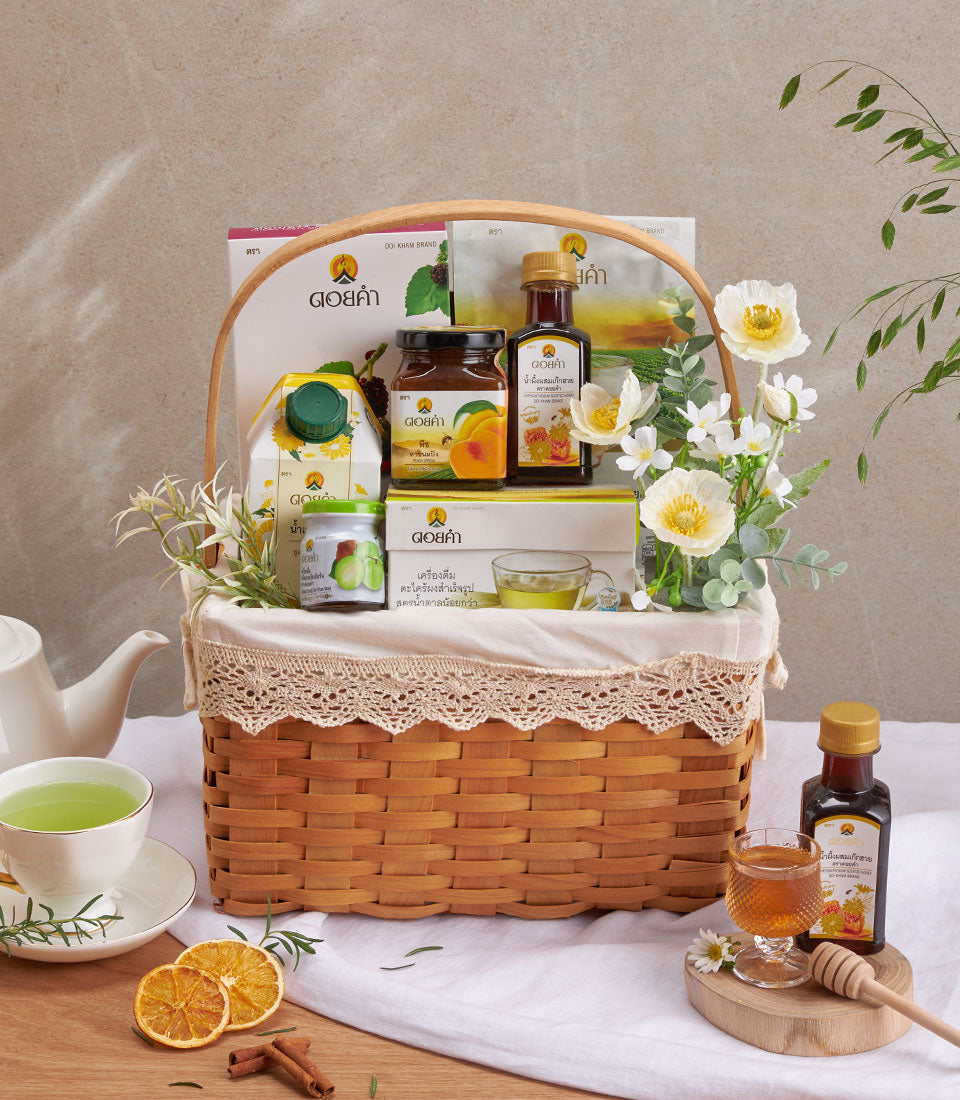 Premium wellness gift basket with herbal teas, natural syrups, and tropical juices in woven basket