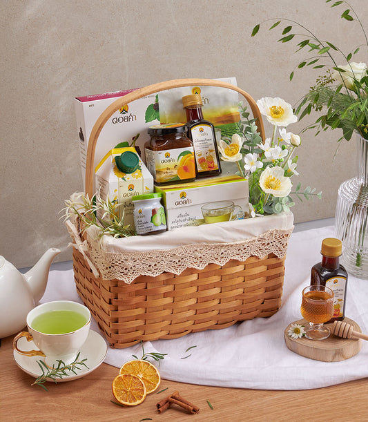 Doi Kham herbal wellness gift basket with organic tea, honey, preserves, and fresh botanicals in woven rattan