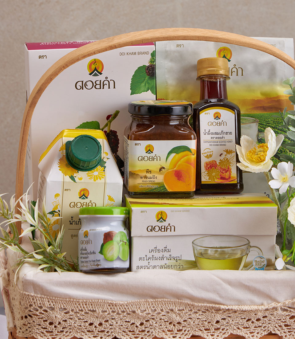Woven gift basket with herbal tea, honey, fruit spreads, and wellness products with white flowers