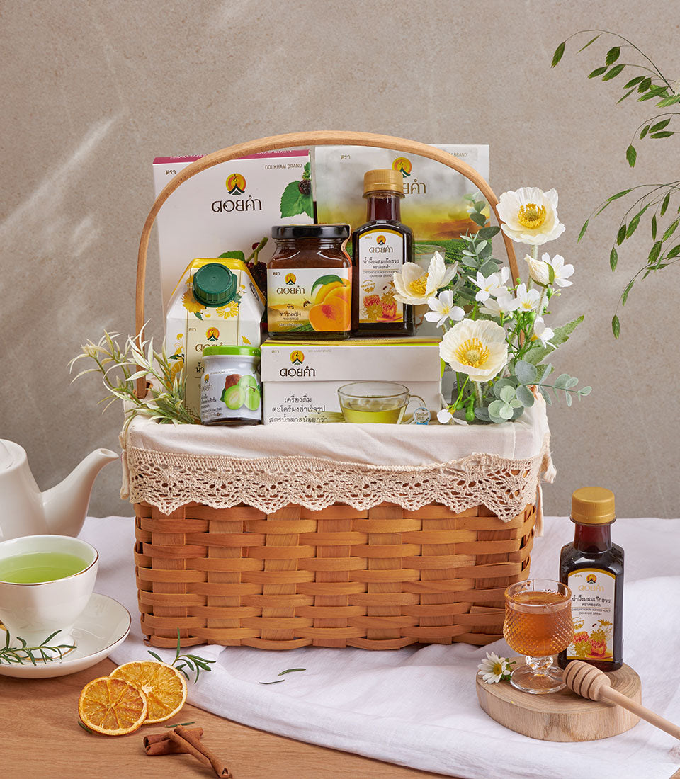 Premium herbal wellness gift basket with organic teas, natural honey, mango jam, and botanical remedies in woven wood