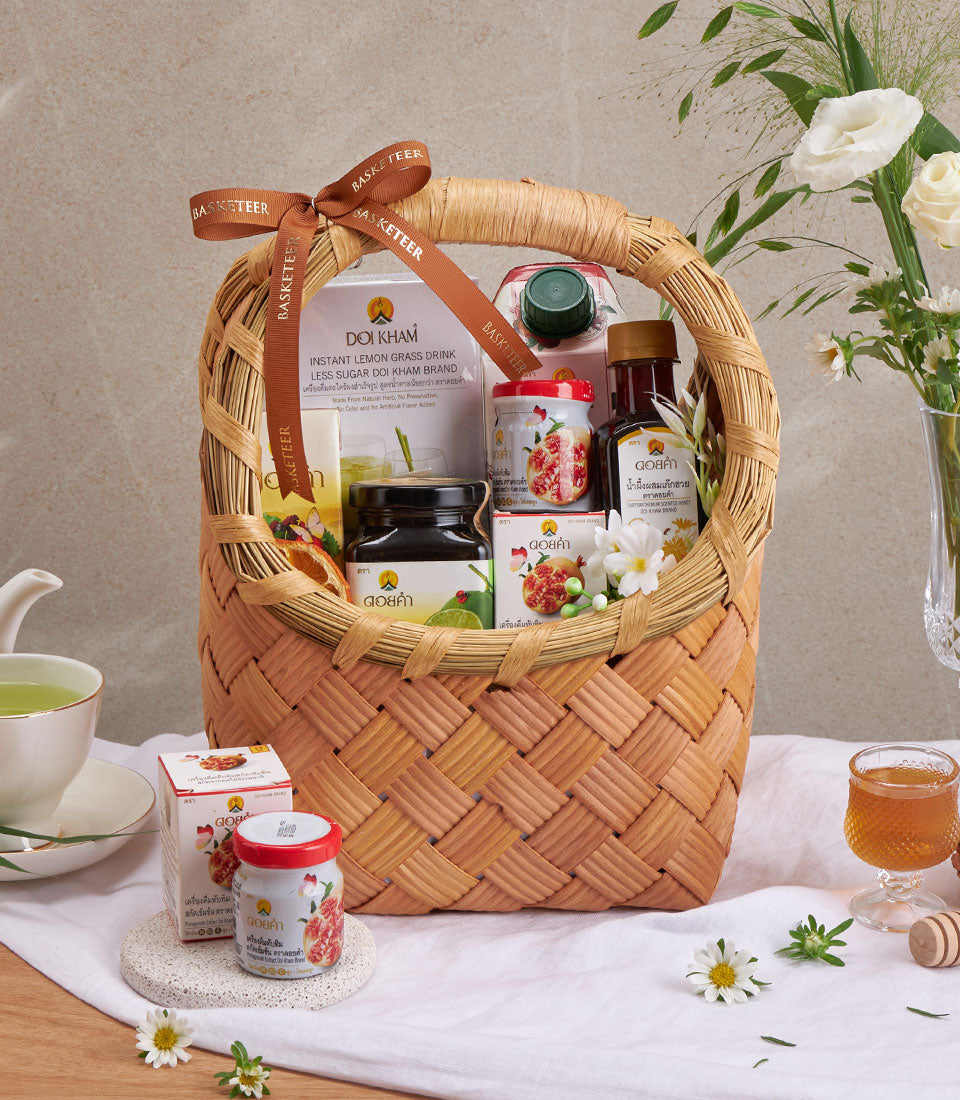 Doi Kham herbal wellness gift basket with lemongrass drink, pomegranate preserve, and natural remedies in woven wicker