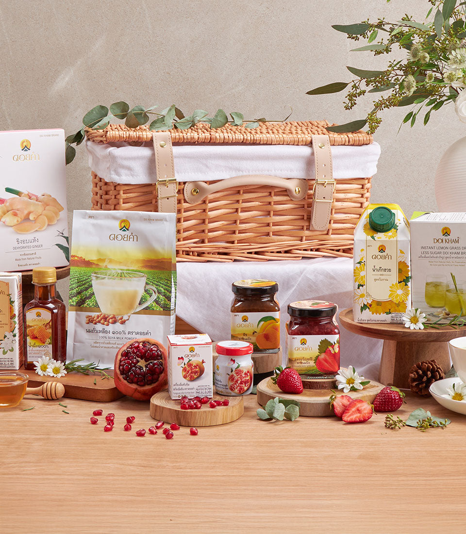 Premium wellness gift hamper with herbal teas, honey, soya milk, and fruit preserves in wicker basket