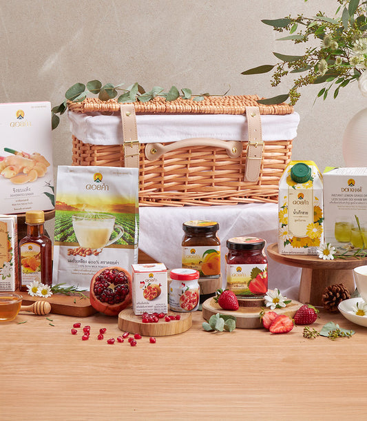 Premium wellness gift hamper with herbal teas, honey, soya milk, and fruit preserves in wicker basket