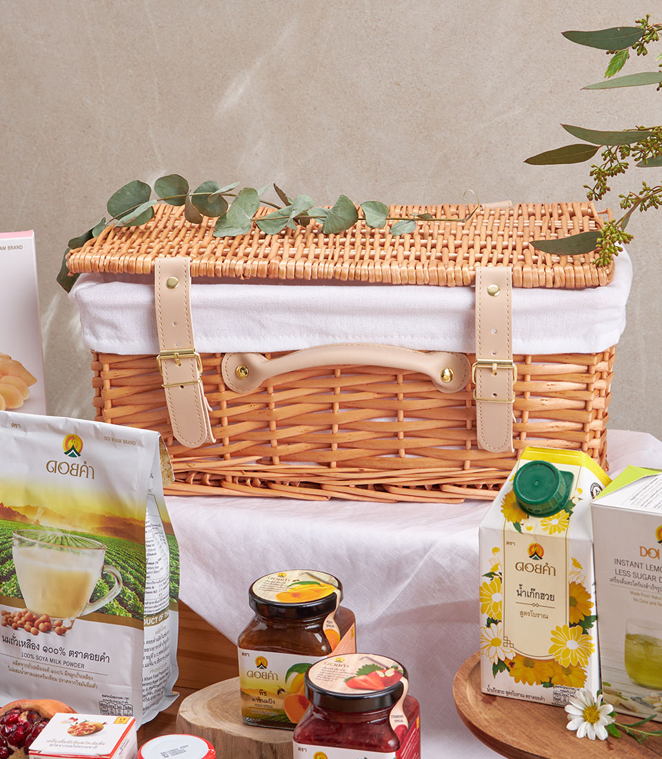 Premium wellness gift basket with organic herbal tea, honey, soya milk powder, and fruit spreads in wicker hamper