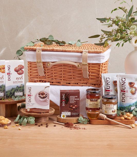 Wicker picnic basket with DoiTung macadamia nuts, coffee, honey, cookies, and chocolate-covered beans gourmet gift set