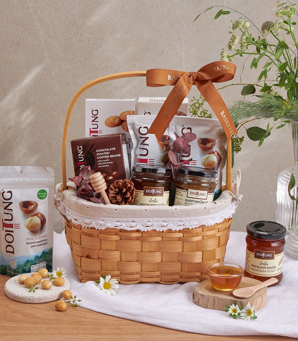 Premium wicker gift basket with macadamia nuts, chocolate coffee beans, and honey jars, artisan gourmet hamper