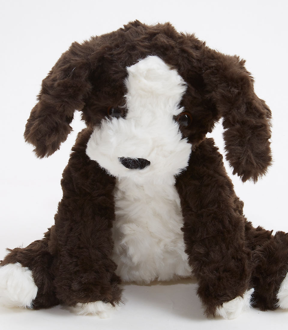 Brown and white plush puppy toy with floppy ears and soft shaggy fur