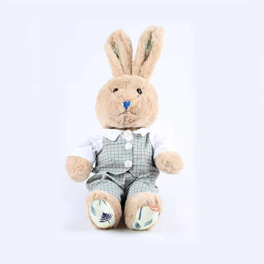 Light brown plush rabbit toy wearing white shirt, checkered vest, and leaf-patterned feet