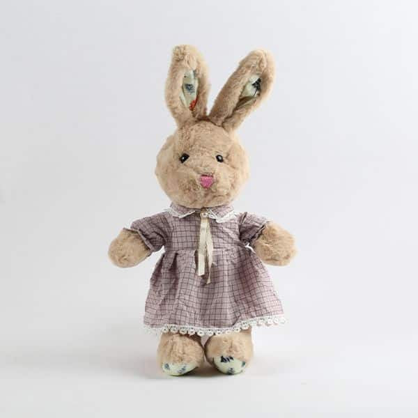 Light brown plush bunny in purple checkered dress with lace collar and cream ribbon bow