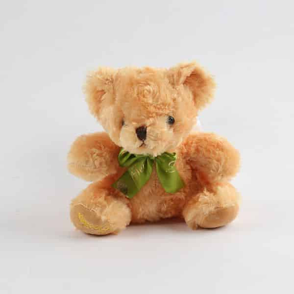 Light brown fluffy teddy bear with green satin ribbon bow, perfect for gift hampers and celebrations
