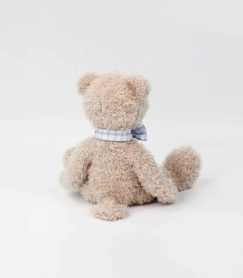 Basketeer plush teddy bear with a blue plaid bow. A charming addition to any luxury gift basket delivery in Bangkok.
